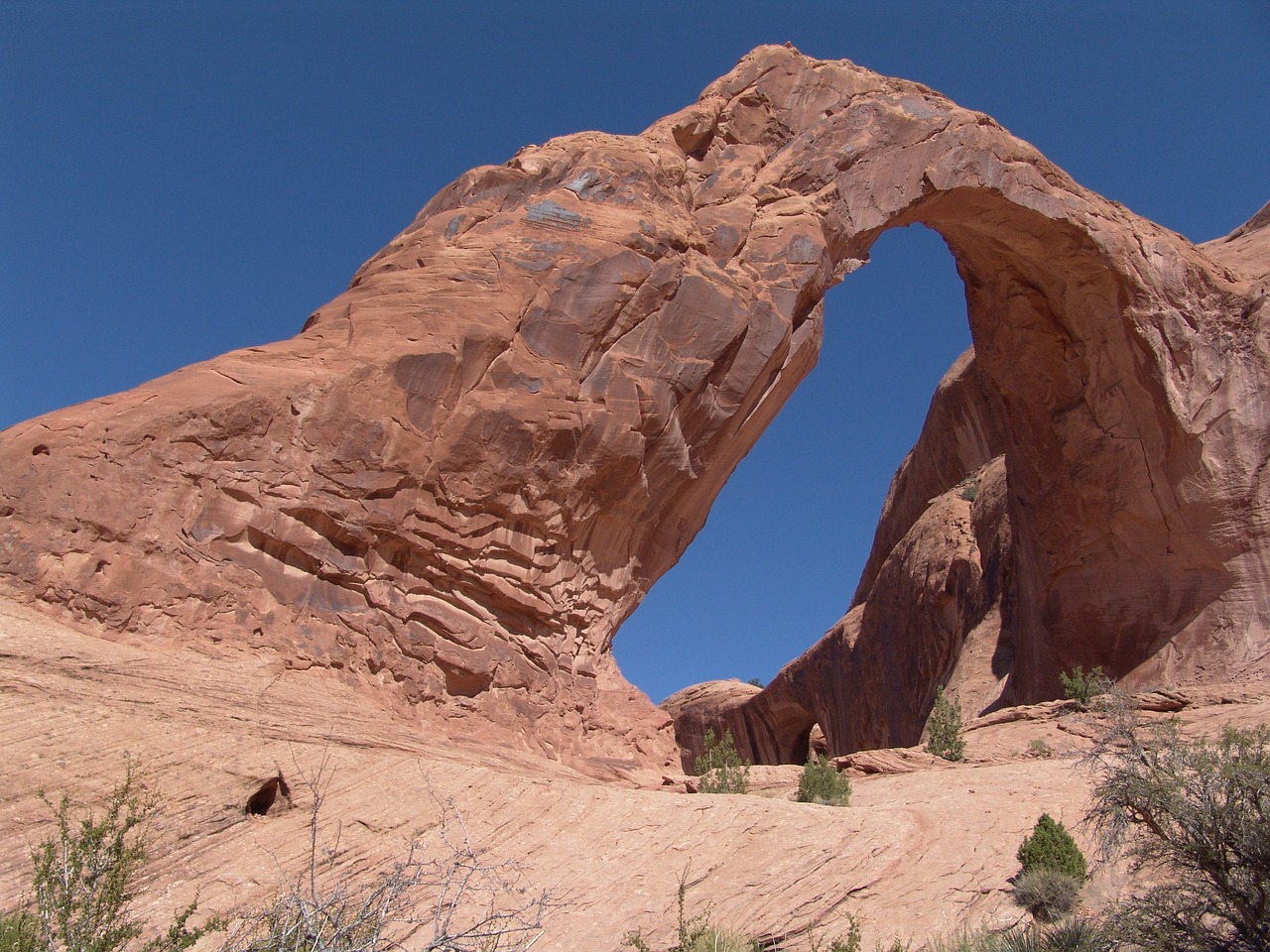 A sandstone arch rock formation in the desert