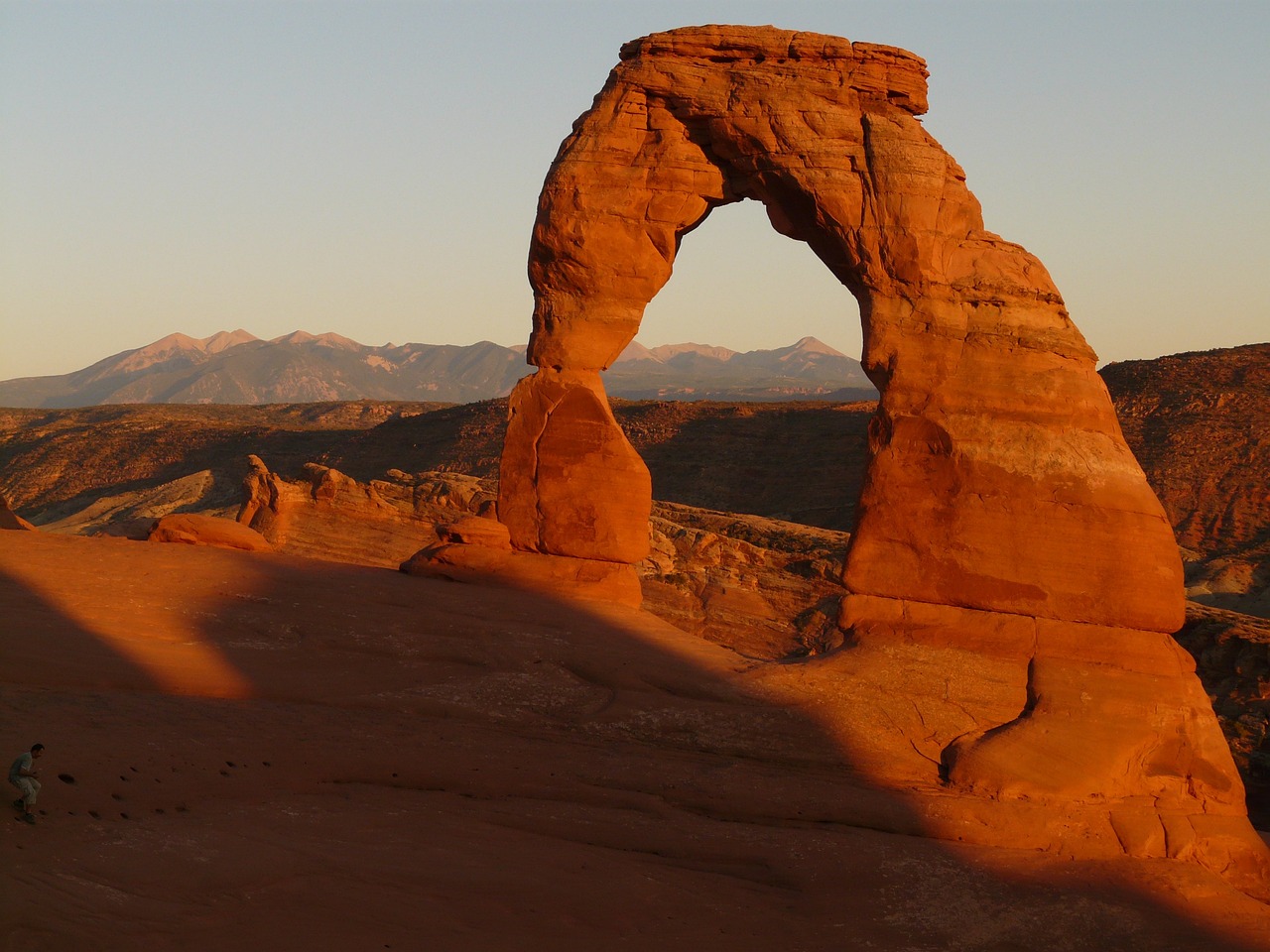 A sandstone arch rock formation in the desert